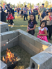 Children roasting marshmallows at a fire pit
