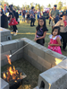 Children roasting marshmallows at a fire pit