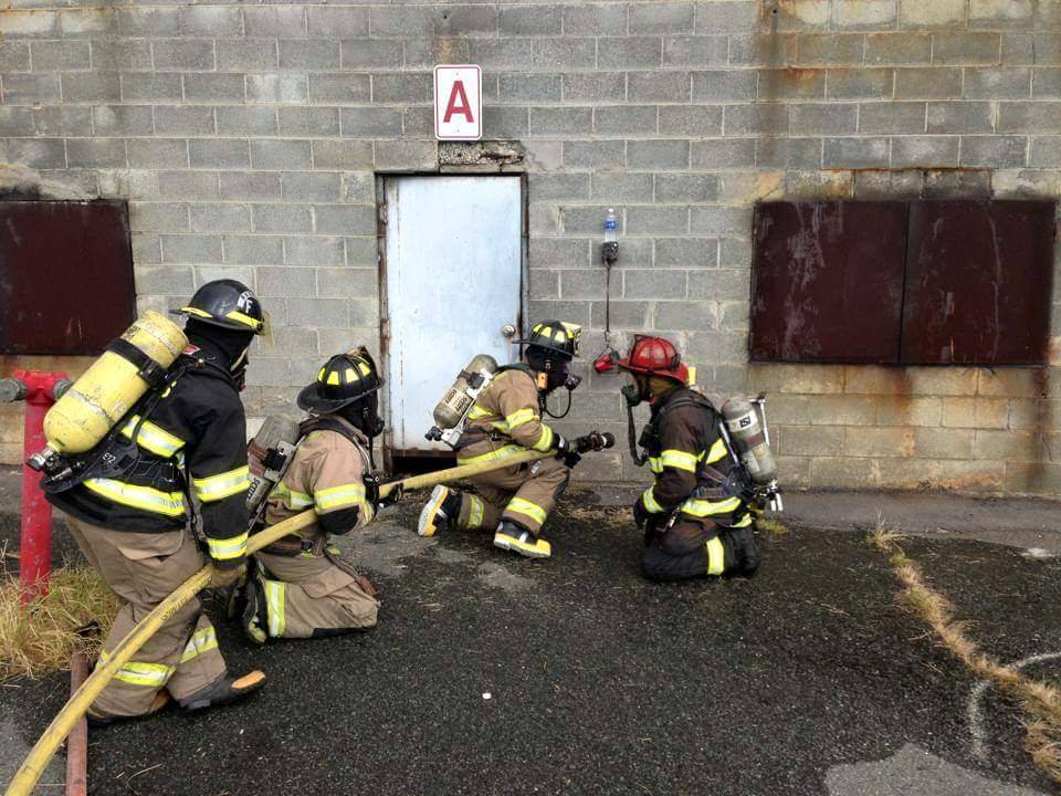 Firefighters Holding a Hose