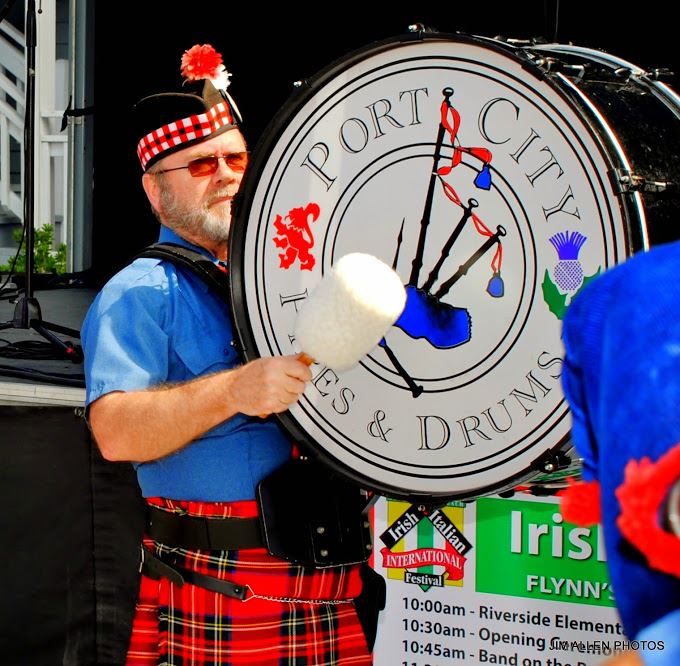 Man Dressed Up and Banging on a Drum