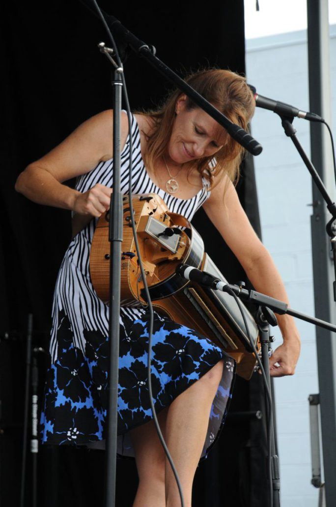 Woman Adjusting Her Instrument on Stage