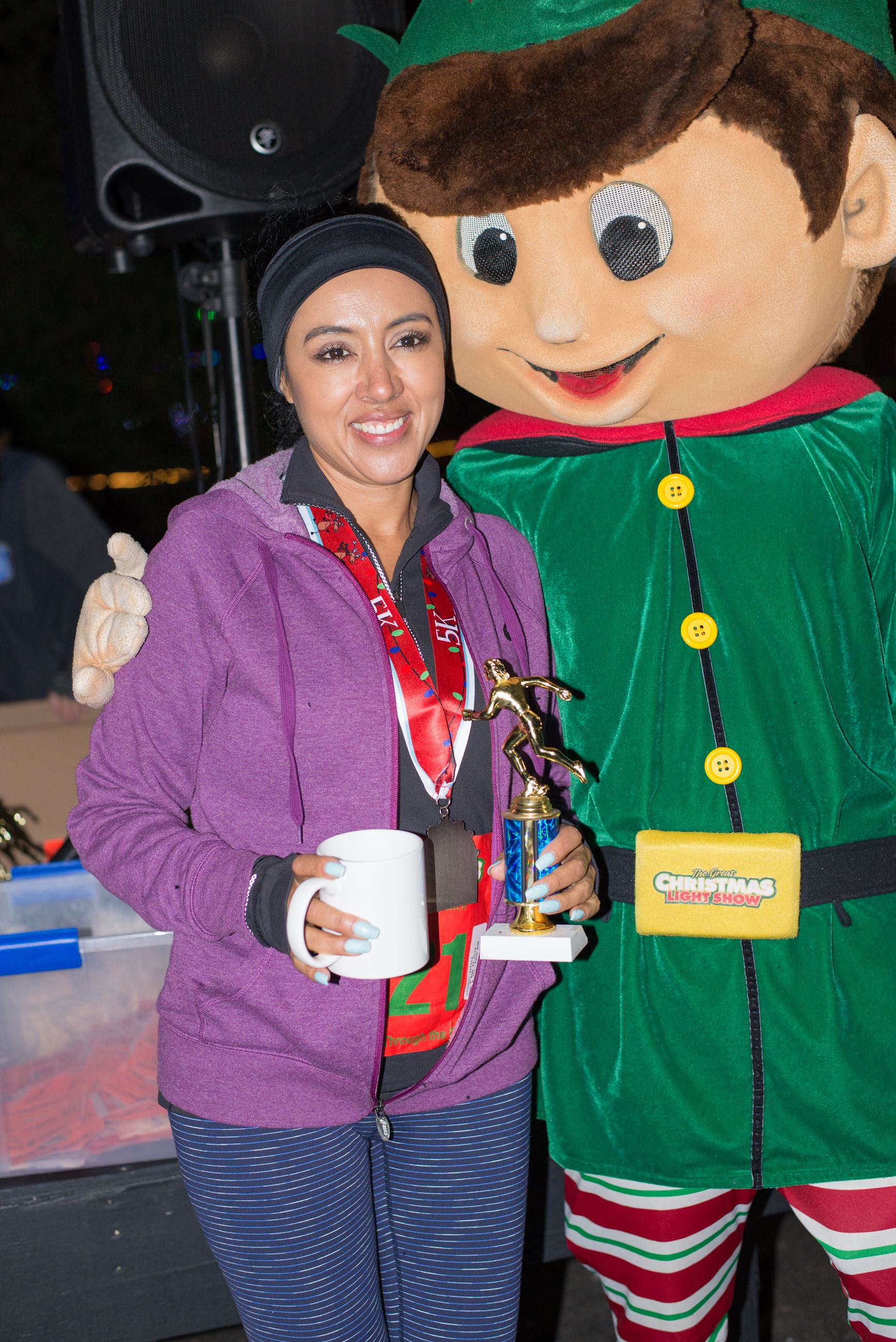 Woman Holding a Mug and Posing with an Elf