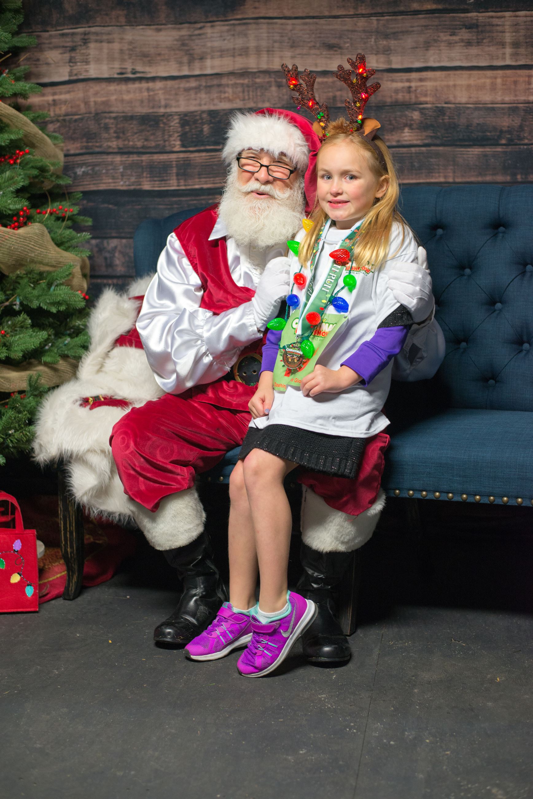 Young Girl Sitting on Santa Claus Lap